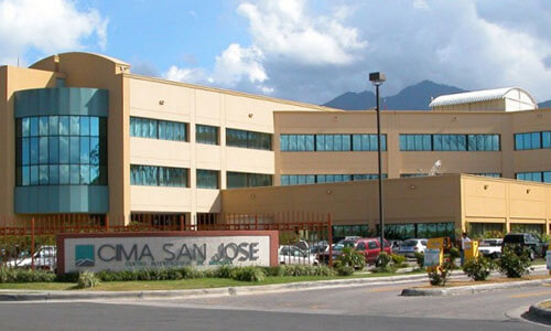 Picture of CIMA Hospital, Costa Rica’s premier advanced Hospital in San Jose, Costa Rica.  The picture shows a large sprawling medical complex with light brown colors.